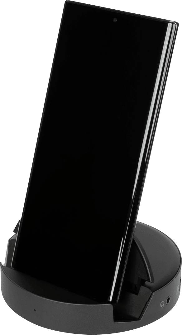 Czarny smartfon stoi pionowo w okrągłej, szarej stacji ładującej. Idealne do bezprzewodowego ładowania i wygodnego użytkowania.