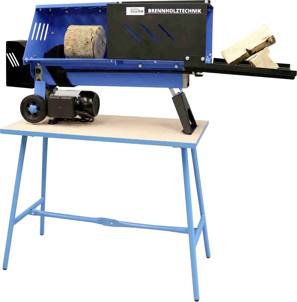 'Łuparka do drewna zamontowana na stole. Kawałki drewna są wkładane po lewej stronie i rozłupywane po prawej. Silnik znajduje się w lewym dolnym rogu.'