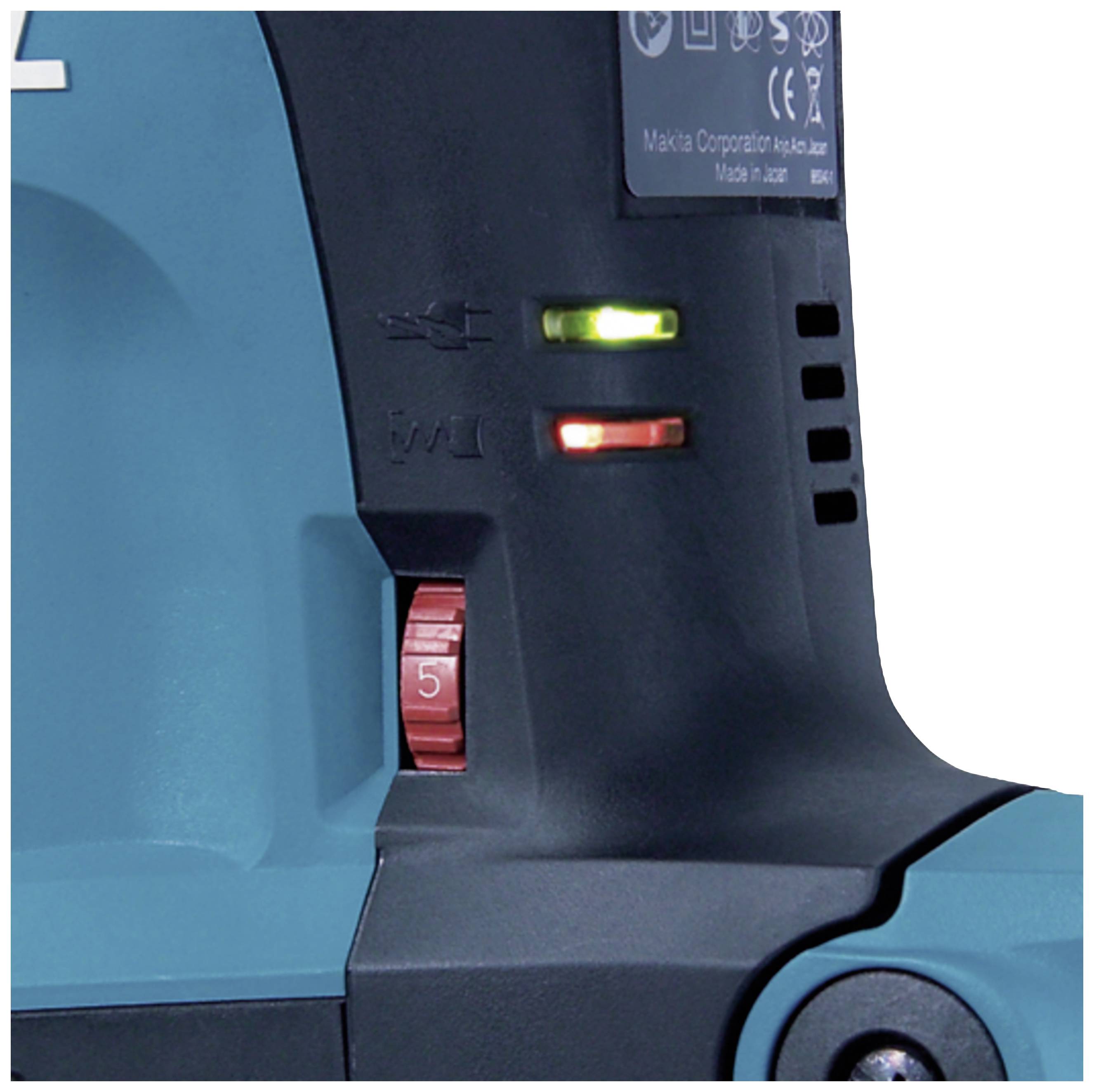 Szczegół elektrycznej maszyny z dwoma świecącymi kontrolkami - czerwoną i zieloną - oraz czerwonym pokrętłem regulacyjnym.