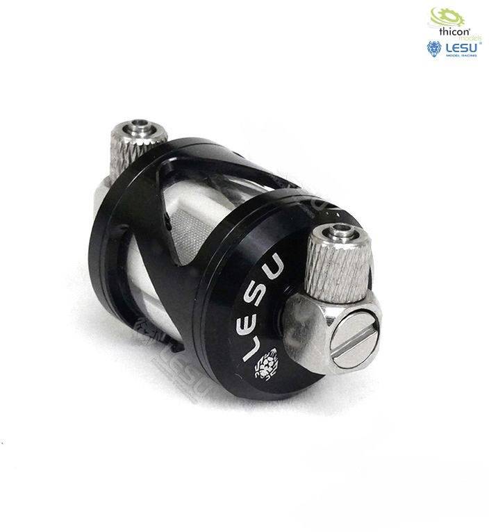 Srebrno-czarna metalowa część z napisem 'LESU', prawdopodobnie element mechaniczny lub akcesoria.