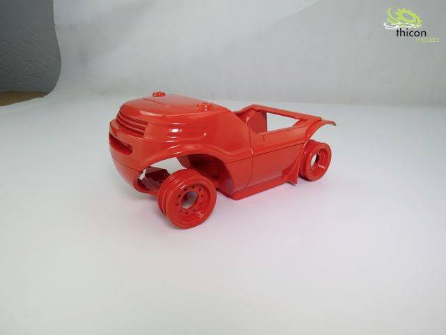 Czerwony samochodzik zabawkowy bez okien i kół na białym tle; logo w górnym prawym rogu.