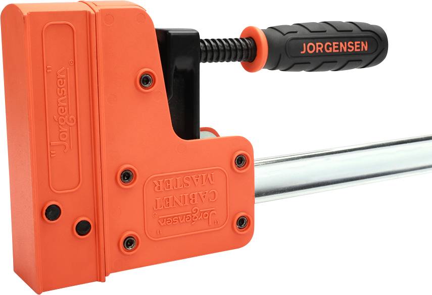 Pomarańczowy zacisk śrubowy z czarną rękojeścią, oznaczony napisem 'Jorgensen', służący do mocowania i przytrzymywania elementów obrabianych.