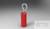 Czerwony, cylindryczny obiekt z metalową pętlą na górze; wygląda jak złącze elektryczne baterii lub przewodu.