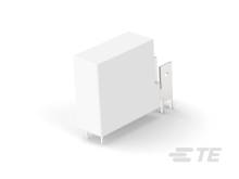 Biały blok z wypukłą, płaską metalową częścią, znajdujący się na szarym podłożu.