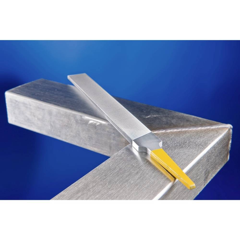 Żółte metalowe narzędzie tnące leży ukośnie na dużej metalowej powierzchni na niebieskim tle.