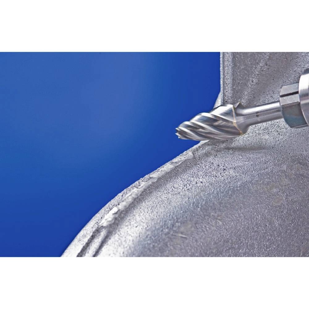 Zbliżenie frezu końcówkowego podczas obróbki elementu metalowego. Frez jest w ruchu i tworzy błyszczące wióry metalowe.