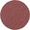 Czerwony papier ścierny w kształcie koła.