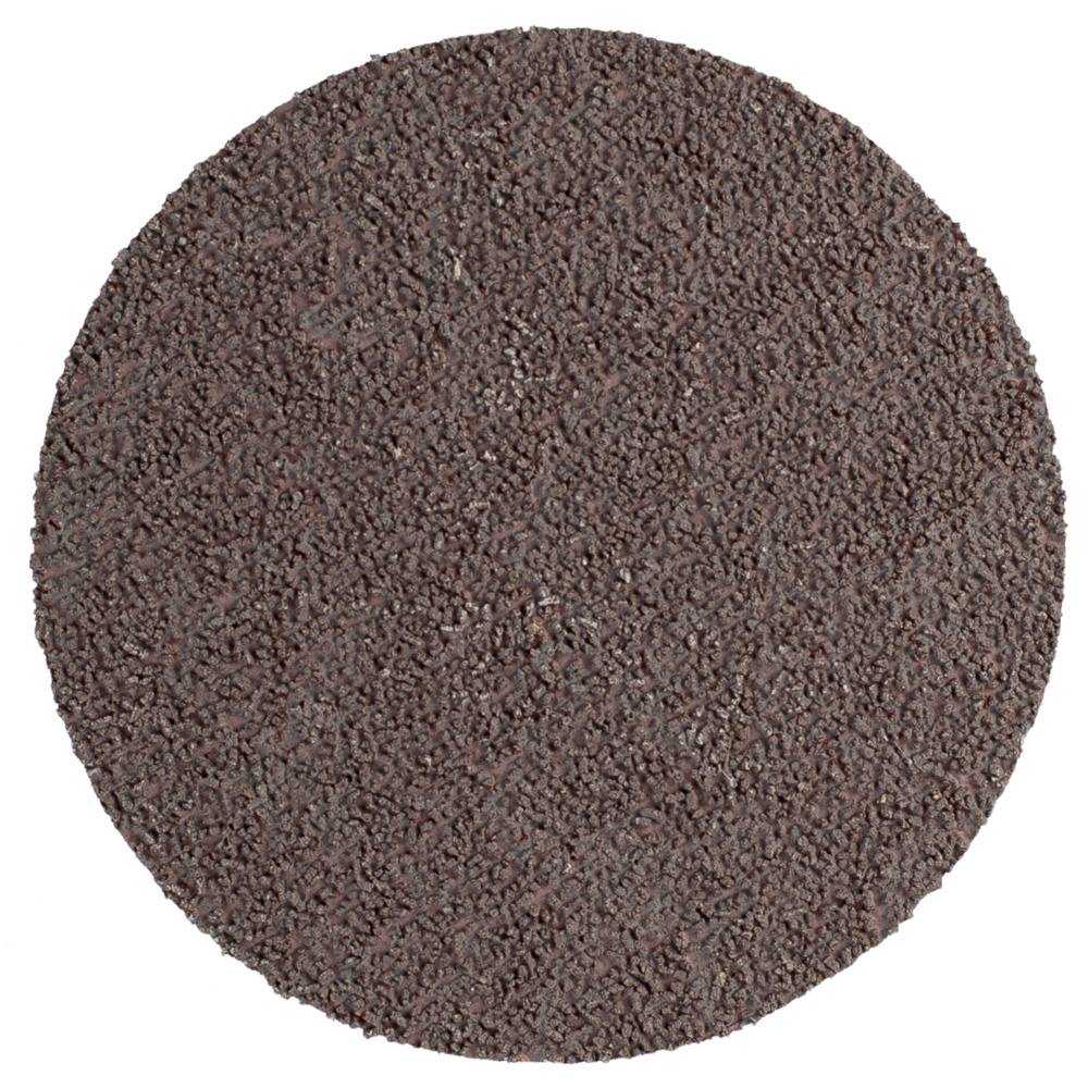 Brązowy krążek papieru ściernego o chropowatej strukturze, używany do szlifowania lub wygładzania powierzchni w pracach rzemieślniczych.