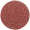 Okrągła, rudoczerwona tarcza ścierna o jednorodnej, chropowatej strukturze, używana do szlifowania powierzchni.