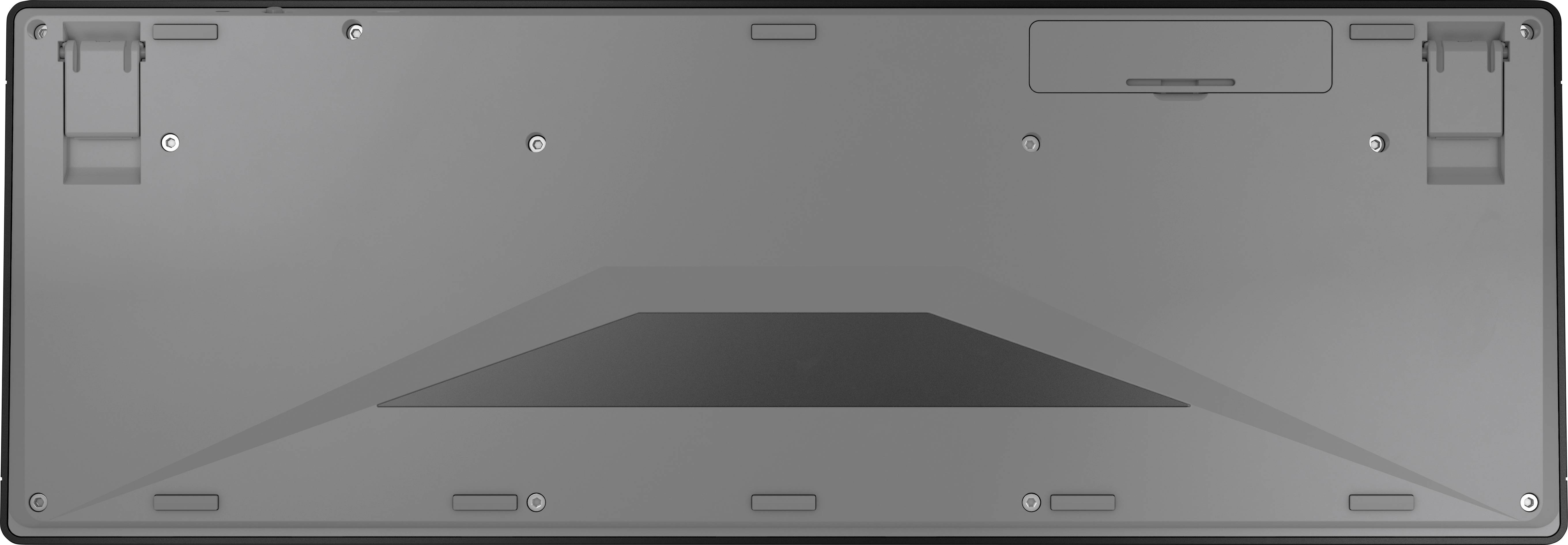 Tylna strona klawiatury z odejmowanymi stopkami. Widoczne są śruby i komora baterii.