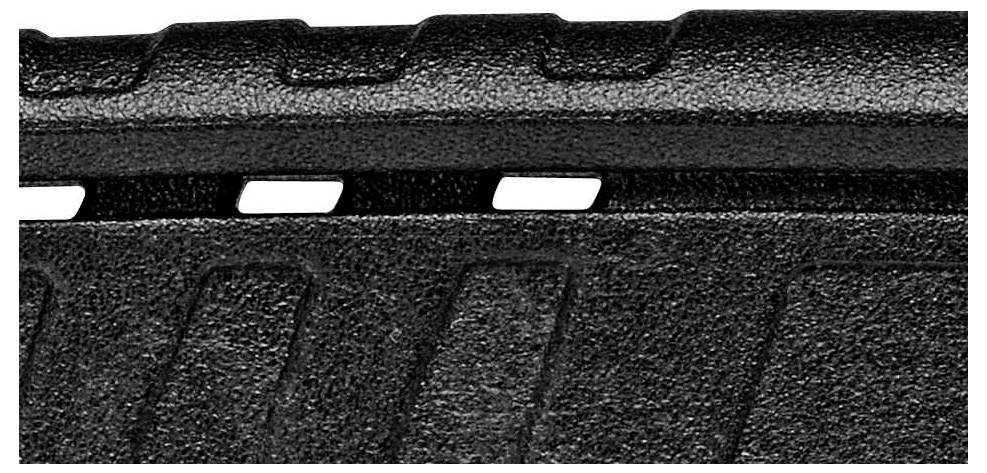 Zbliżenie strukturowanej czarnej powierzchni z liniowym wzorem i prostokątnymi wycięciami przy krawędziach.