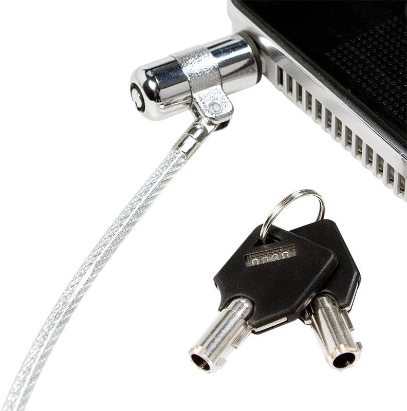Kabel zabezpieczające do laptopa podłączone do komputera. Obok leżą dwa klucze. Chroni przed kradzieżą.