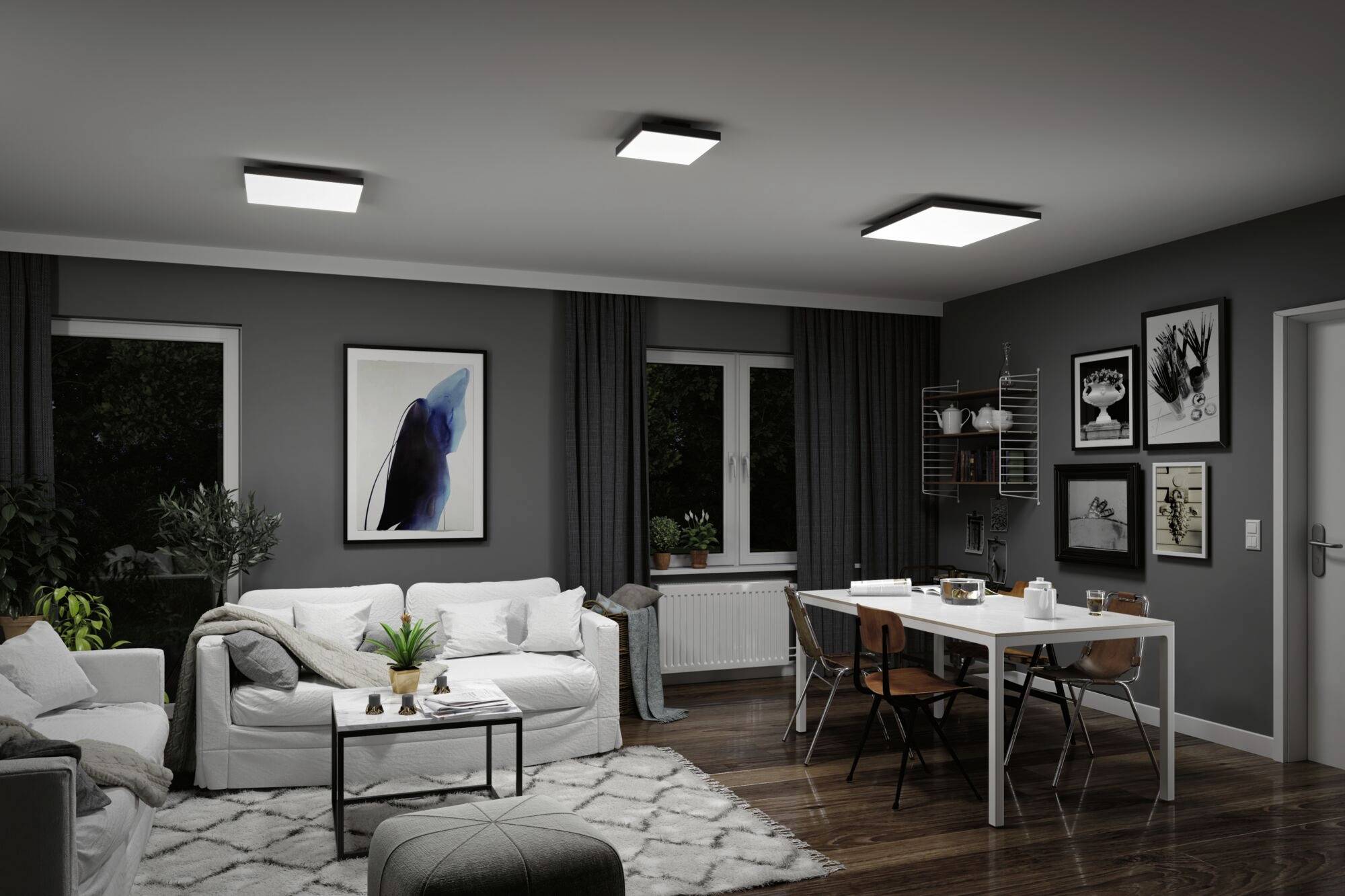Salon z szarymi ścianami, białymi sofami i stołem jadalnianym. Nowoczesne lampy sufitowe oświetlają pomieszczenie, stylowe dzieła sztuki wiszą na ścianach.