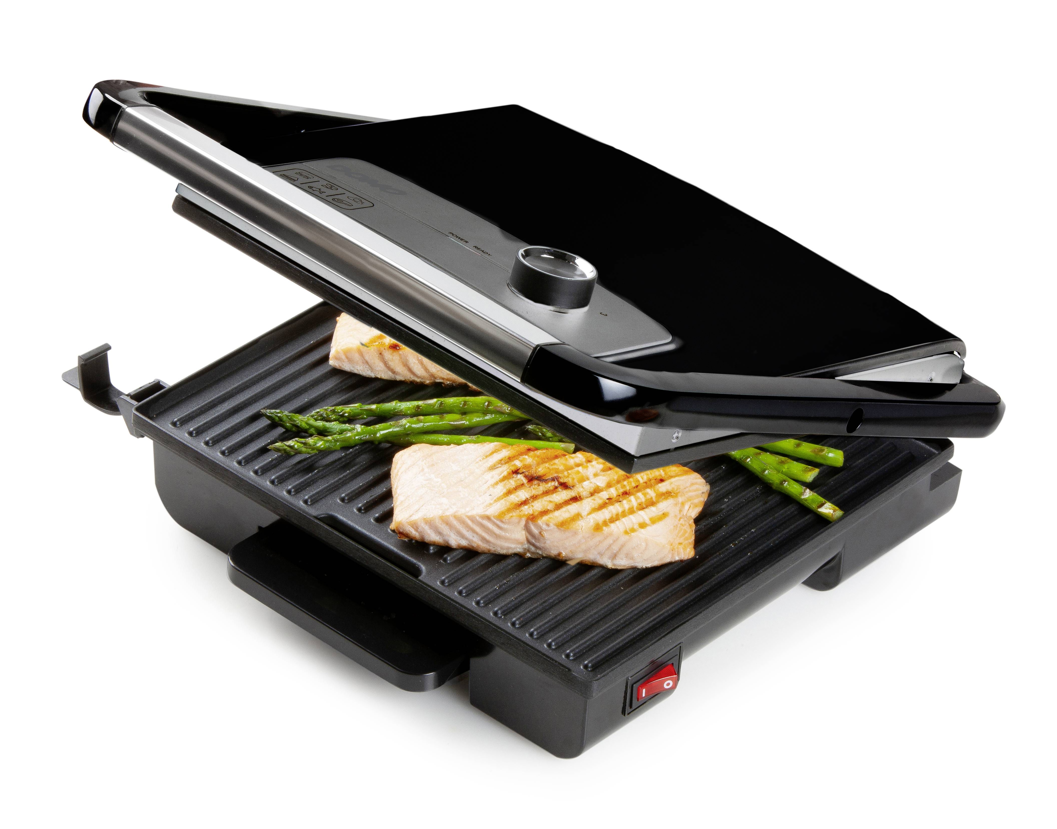 Grill kontaktowy z otwartą pokrywą grilluje dwa filety z łososia i szparagi.