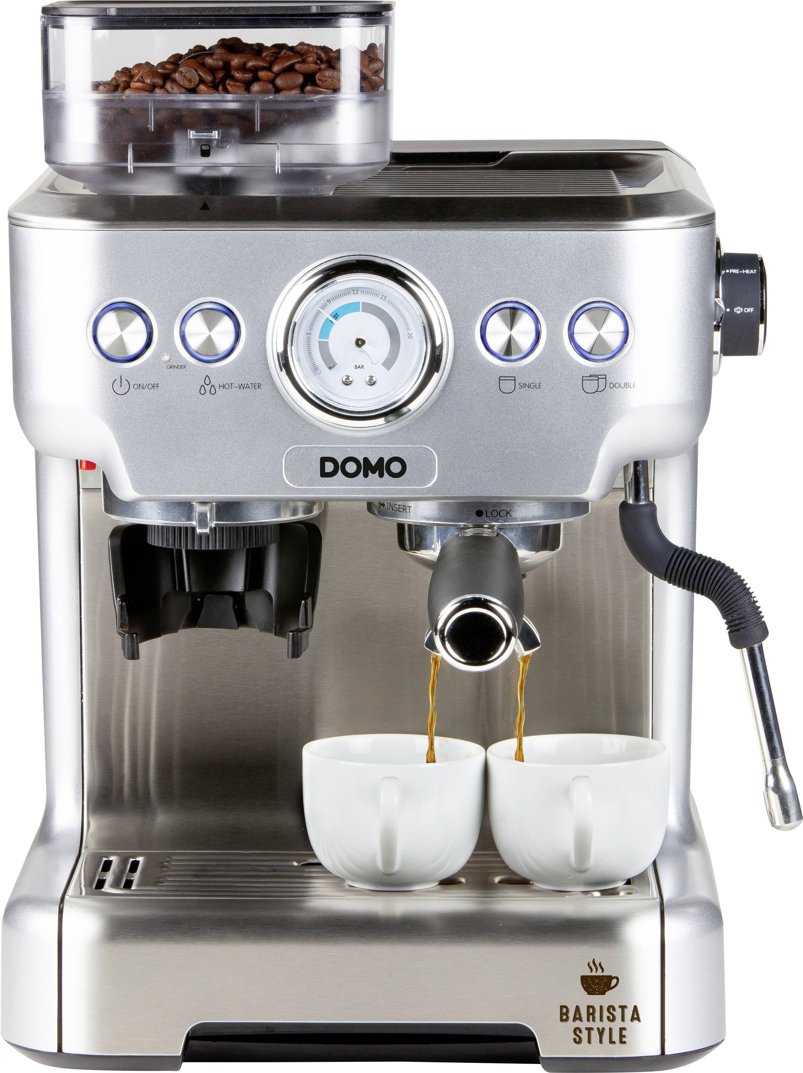 Srebrny ekspres do espresso z dwiema filiżankami pod wylewkami. Ziarna kawy widoczne są na górze. Przyciski sterujące z symbolami.