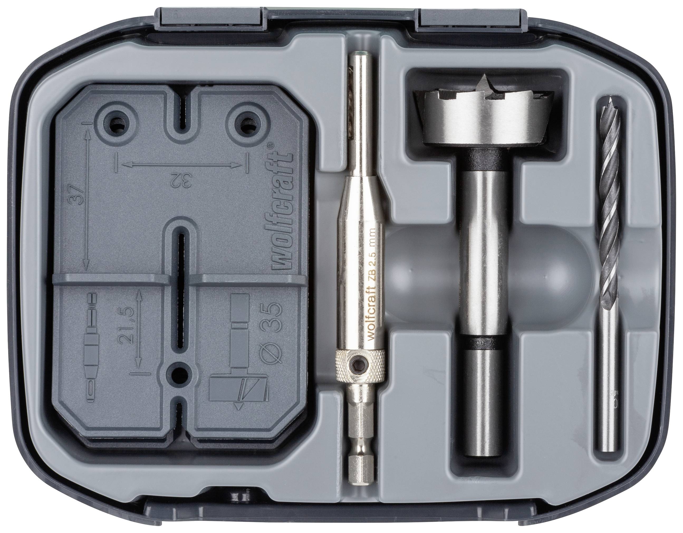 Zestaw koronek wiertniczych w walizce z tworzywa sztucznego. Zawiera wiertło, piłę otworową i akcesoria ułożone w profilowanej wkładce.