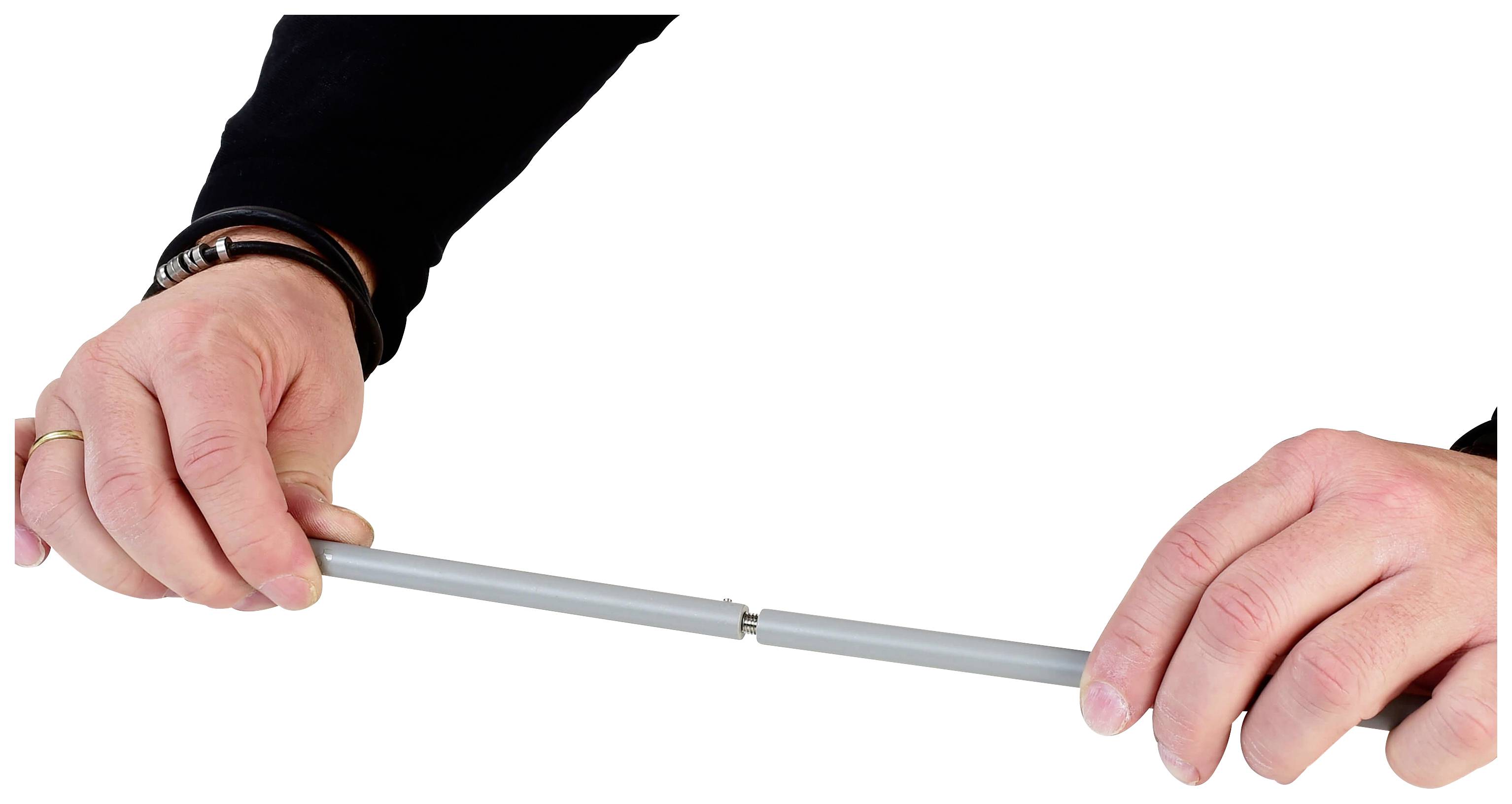 Dwie ręce trzymają szary przewód z połączeniem w środku, które jest rozciągane.