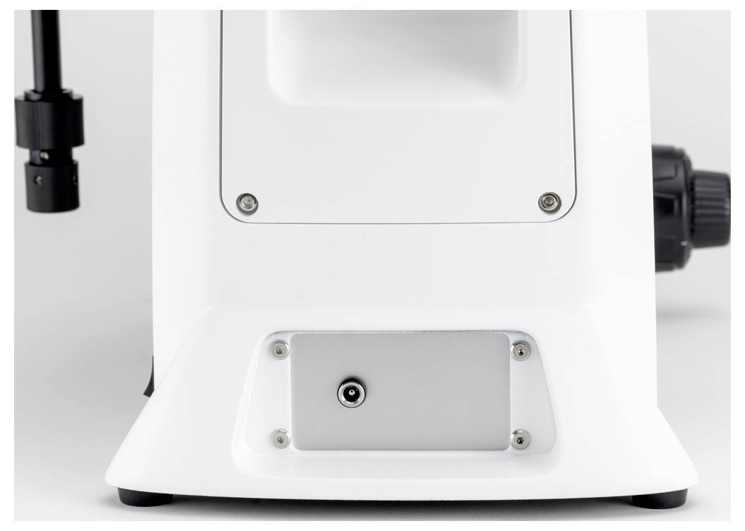 Białe cylindryczne urządzenie z czarnym złączem z boku, prawdopodobnie przyrząd techniczny lub sprzęt laboratoryjny.