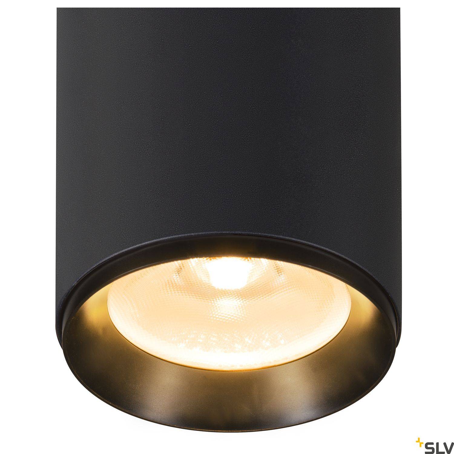 Czarna, cylindryczna lampa sufitowa z widoczną, okrągłą żarówką, emitująca ciepłe, ukierunkowane światło.