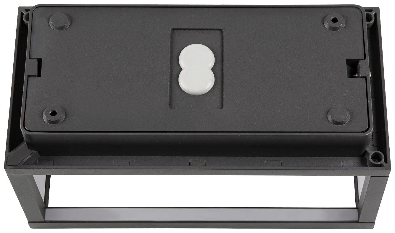 Prostokątny czarny element z małą, owalną, białą wstawką pośrodku, umieszczony w otwartym uchwycie.