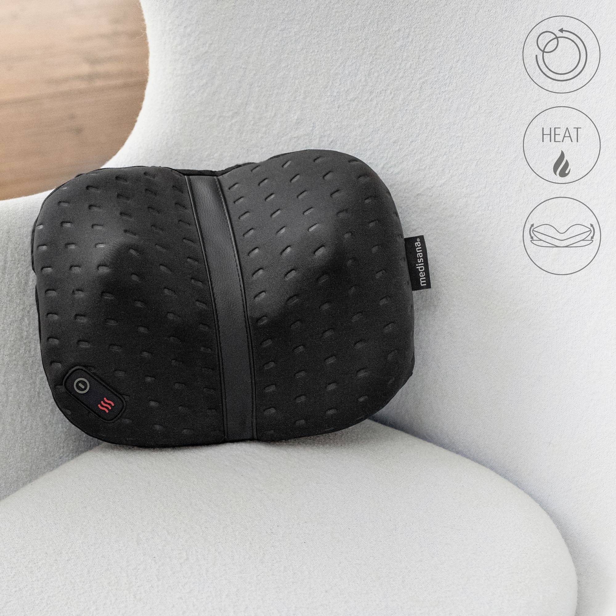 Czarny poduszka do masażu o fakturze w kropki leży na białym fotelu. Widoczne są symbole ogrzewania i masażu.