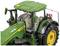 Zielony traktor z żółtymi kołami, widziany z boku. Traktor posiada kabinę kierowcy i logo 'John Deere' na burtcie.