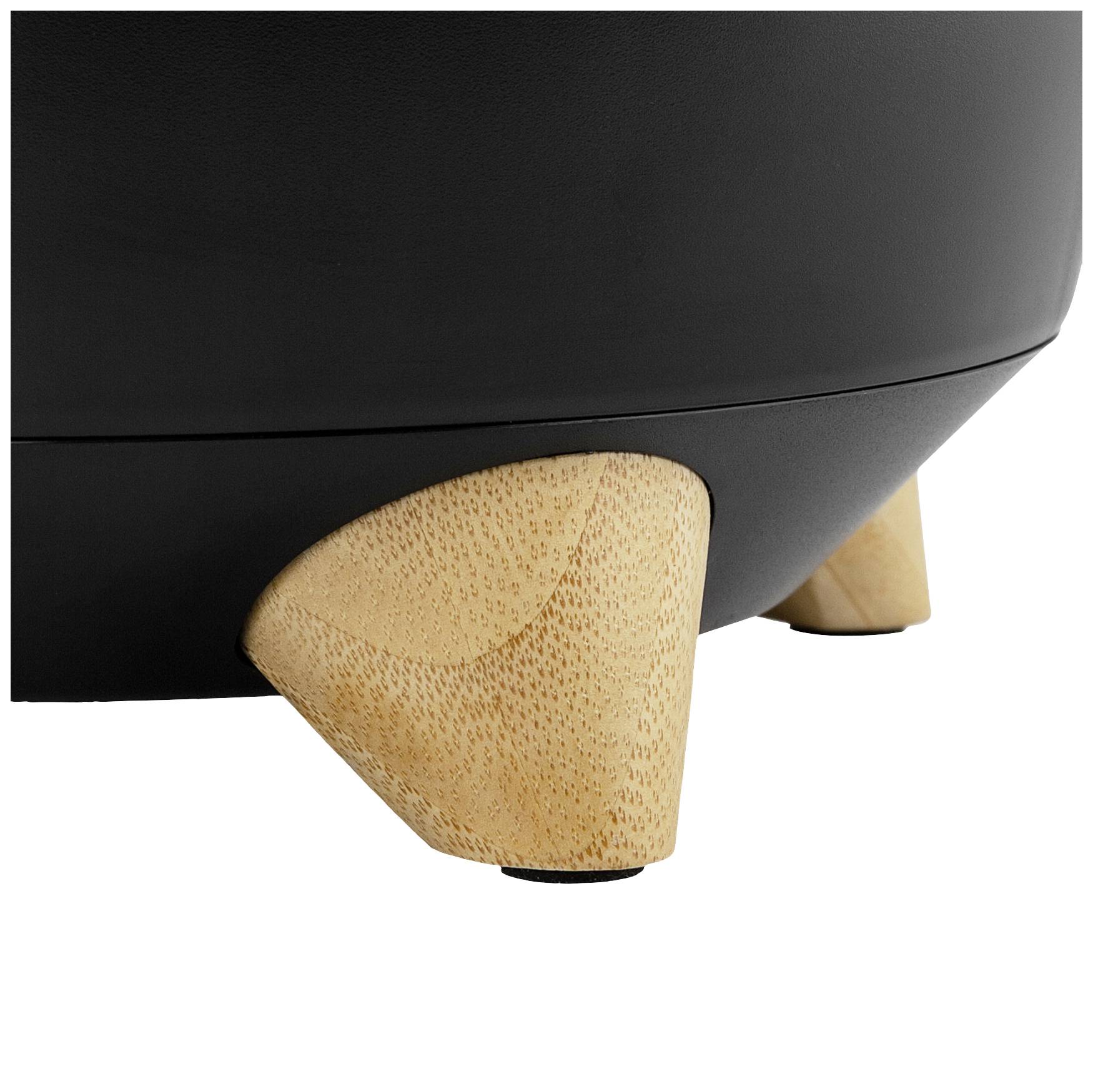 Drewniane nóżki okrągłego, czarnego mebla. Okrągła, stożkowata forma nóg. Widoczne nowoczesne elementy designu.