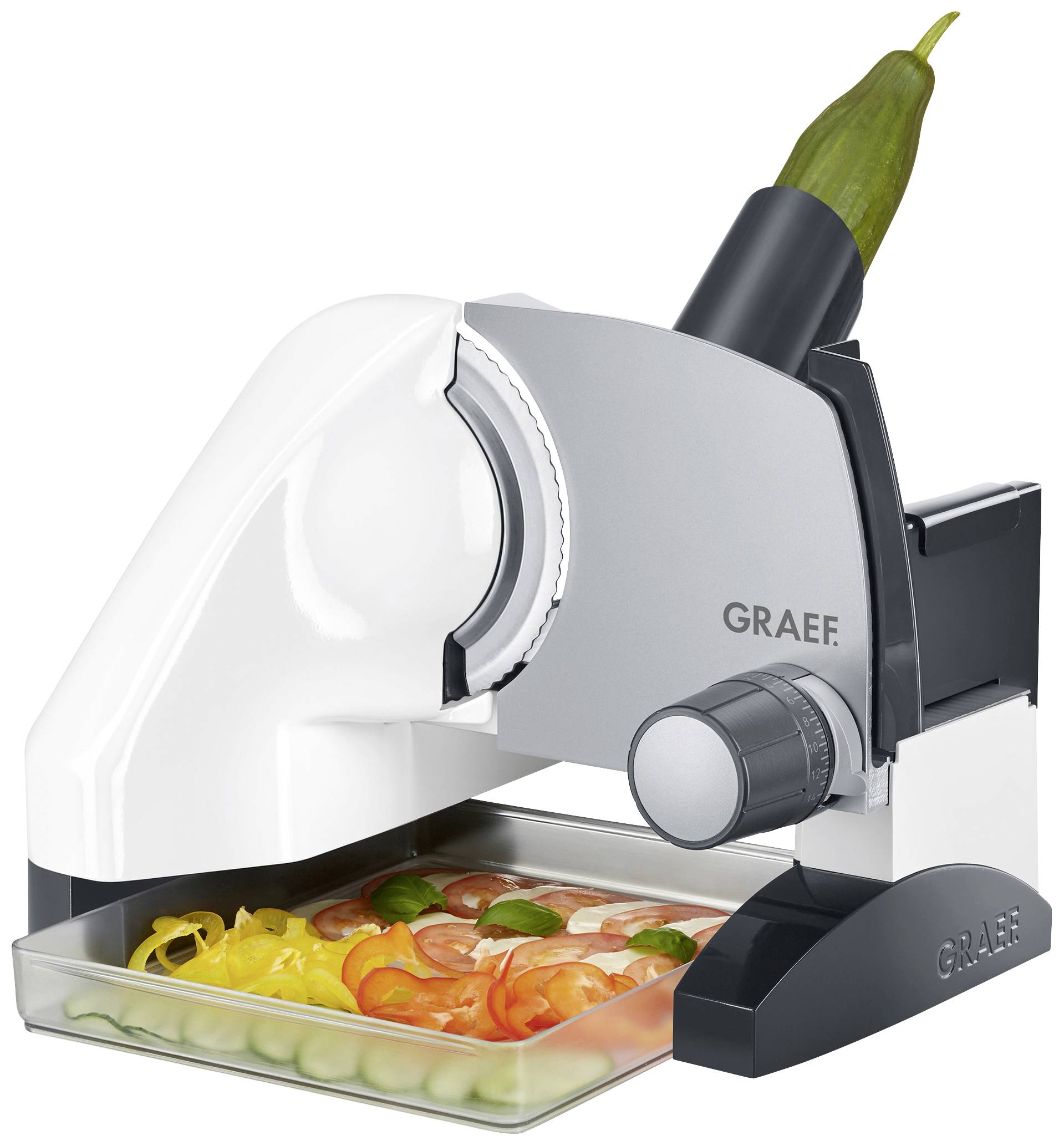 Elektryczny wielofunkcyjny nóż z szarką obudową. Zawiera tackę z pokrojonymi warzywami: marchewką, ogórkami, papryką.