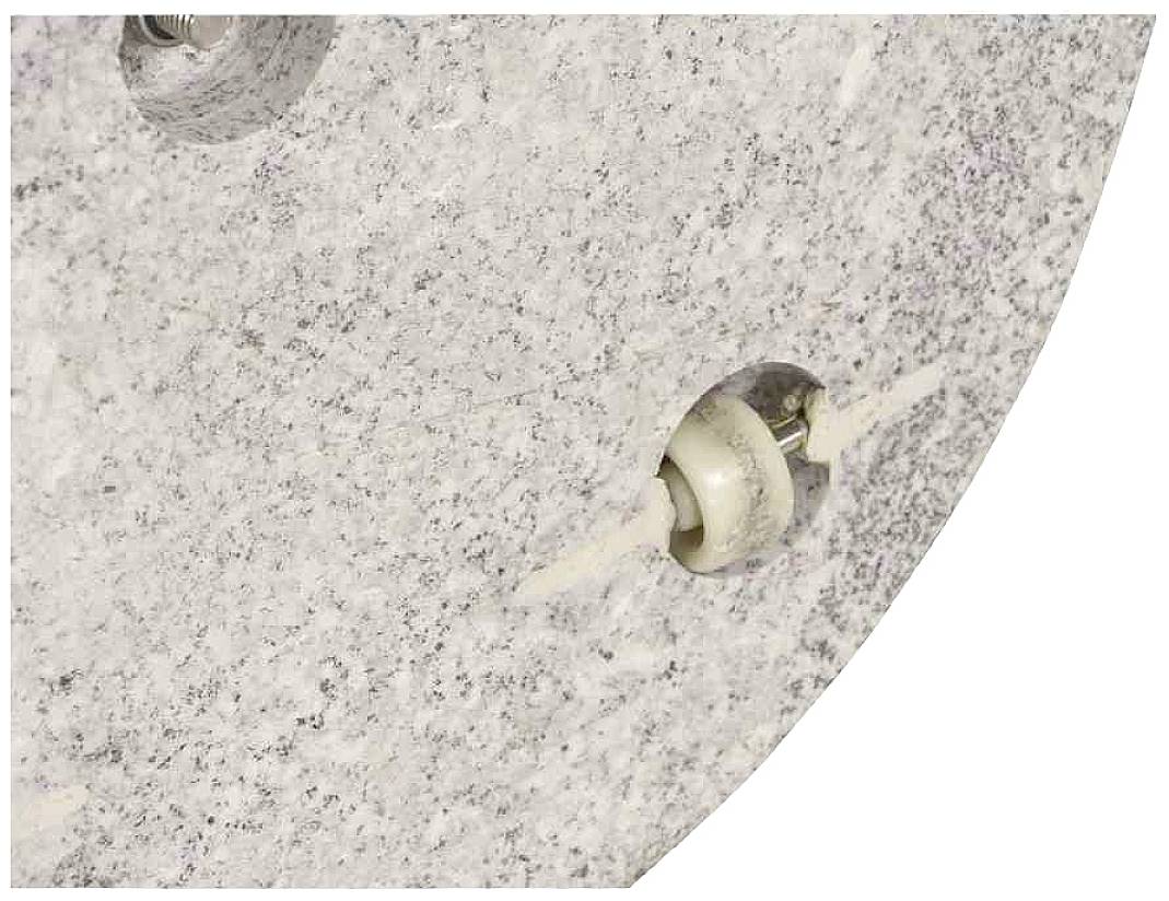 Zbliżenie szarej, strukturowanej powierzchni z wkrętem mocującym i przewodem przechodzącym przez otwór.