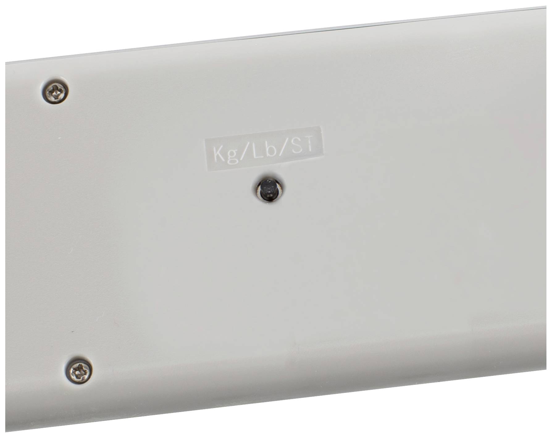 Tylna strona urządzenia z oznaczeniem 'Kg/Lb/St' i kilkoma śrubami.