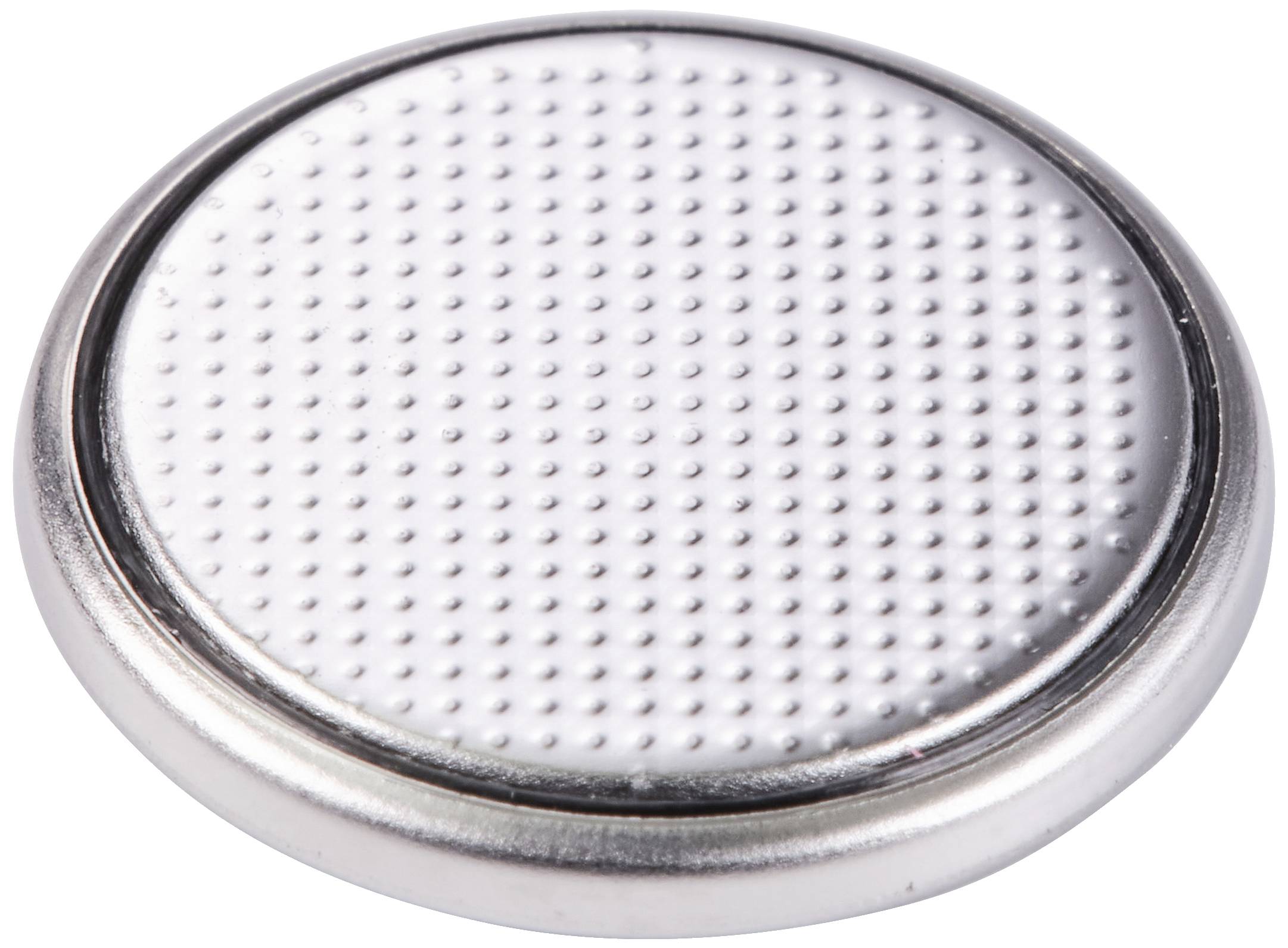 Srebrna bateria guzikowa z powierzchnią w kropki, typowo stosowana w małych urządzeniach elektronicznych, na białym tle.