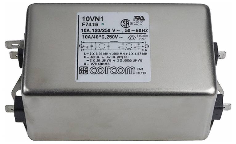 Prostokątny metalowy komponент elektryczny oznaczony „filtr EMI corcom 10A, 120/250V, 50-60Hz" z złączami i oznaczeniami certyfikacyjnymi.