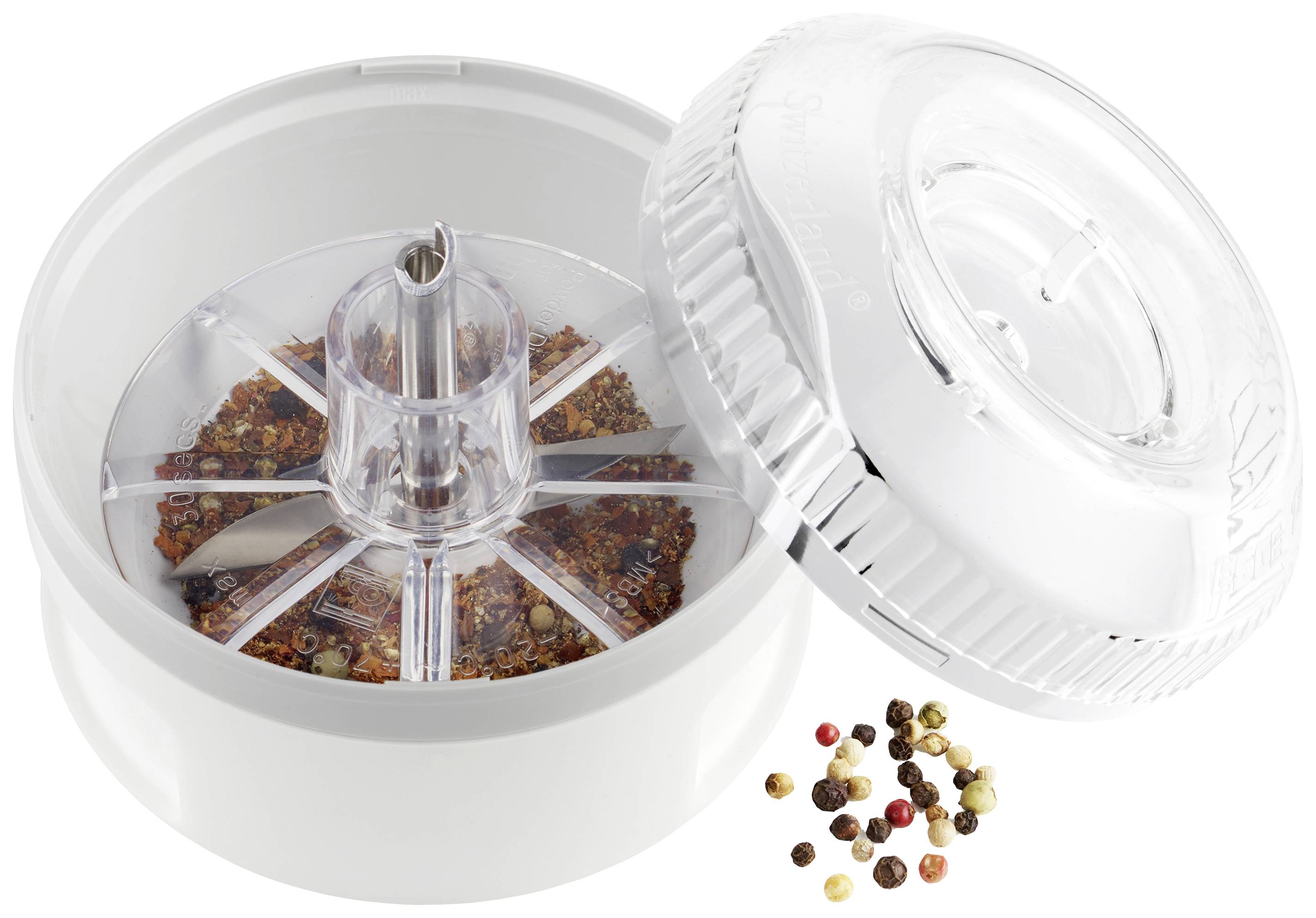 'Otworzony zestaw młynków do przypraw wypełniony różnymi rodzajami ziaren pieprzu, które są częściowo rozsypane obok niego.'