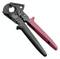 Szczypce do zaciskania z czarną i czerwoną rączką, rozłożone, przeznaczone do obróbki przewodów elektrycznych.