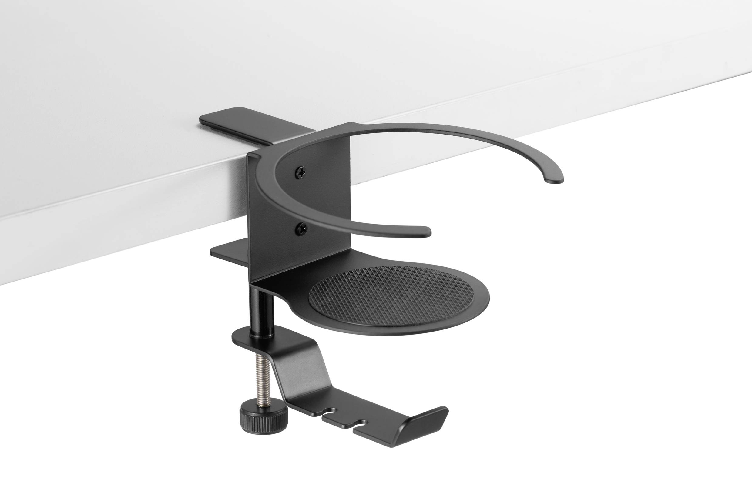 Czarny uchwyt na napoje jest zaciśnięty na krawędzi białego stołu. Uchwyt posiada okrągłą podstawę i otwartą stronę.