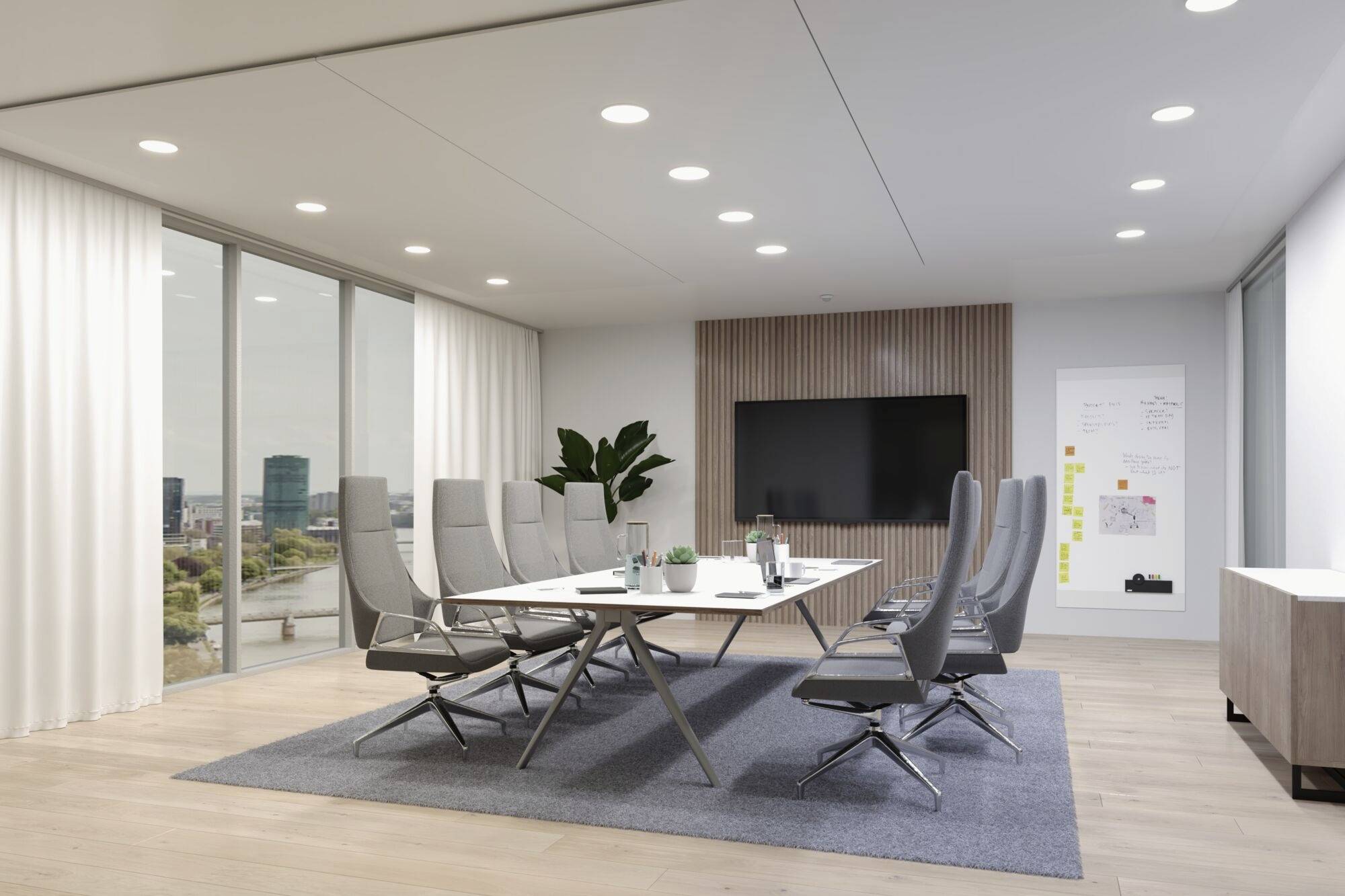 Nowoczesna sala konferencyjna z dużym stołem, wieloma krzesłami, ekranem na ścianie i wielkimi oknami z widokiem na zewnątrz.
