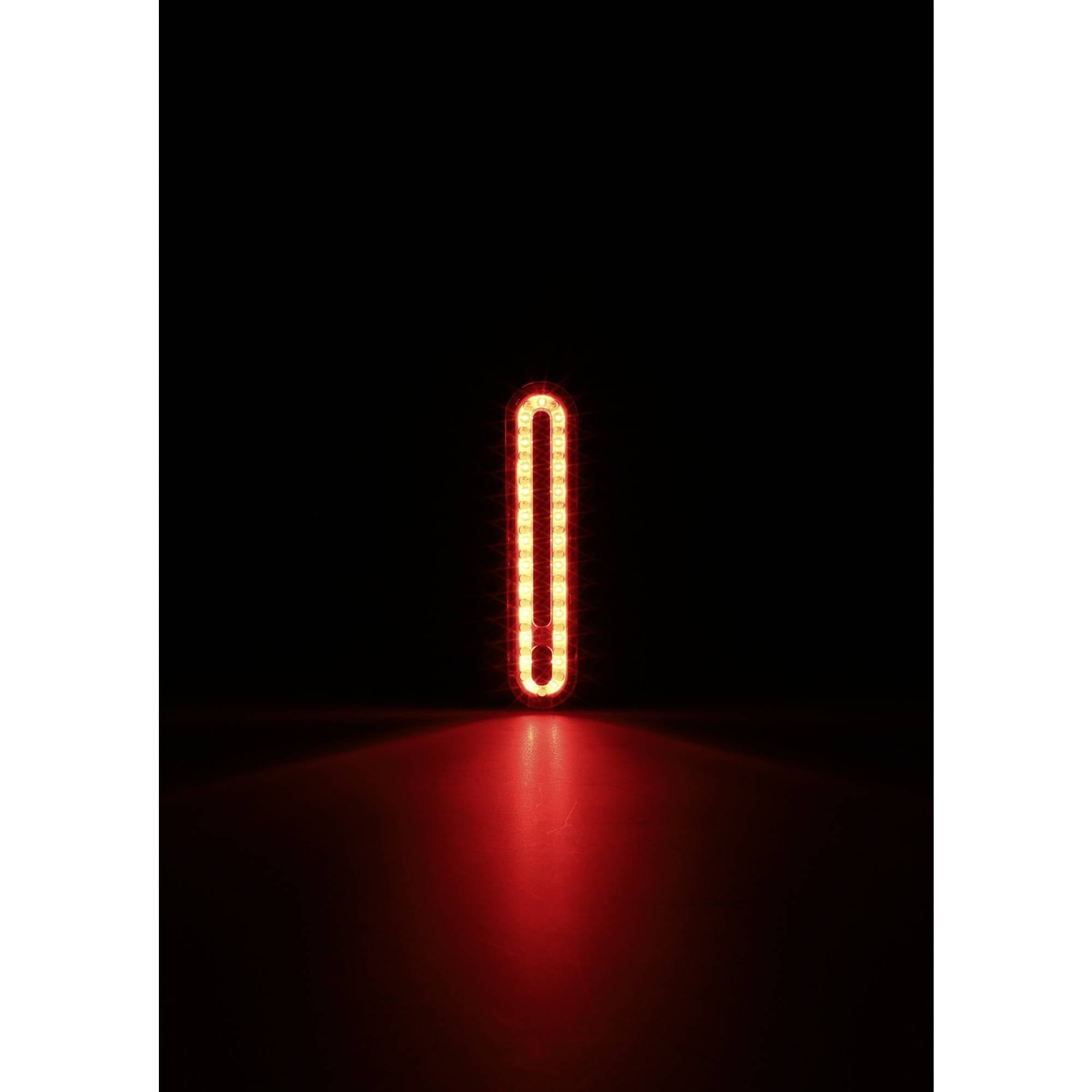 Jasne, pionowe, czerwone światło w ciemności, wyglądające jak stojąca linia.