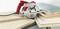Ręczna piła tarczowa z czerwonym uchwytem przecina ułożone na stole drewniane płyty o różnej grubości.