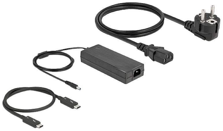 Zasilacz z różnymi kablami, w tym przewodem zasilającym z wtyczką oraz kablem adapter.