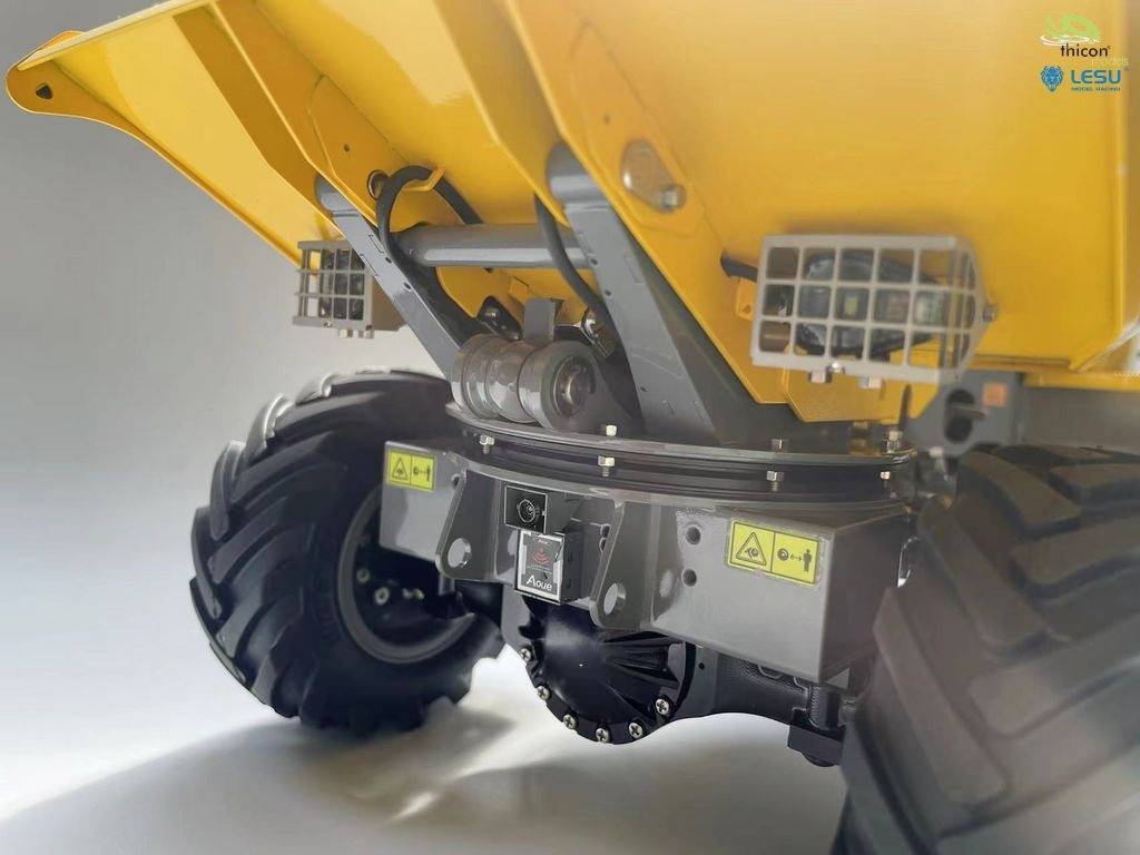 Żółty model pojazdu z dużymi kołami i otwartą tylną częścią, prezentujący cechy konstrukcyjne.