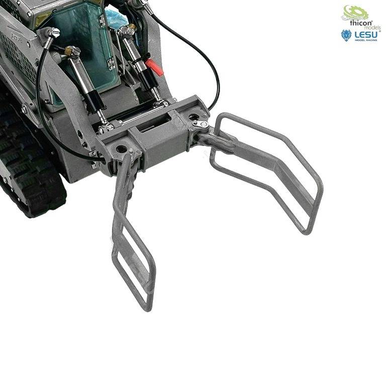 Model zdalnie sterowanego pojazdu gąsienicowego z hydrauliczną łyżką, odpowiedni do małych projektów budowlanych.