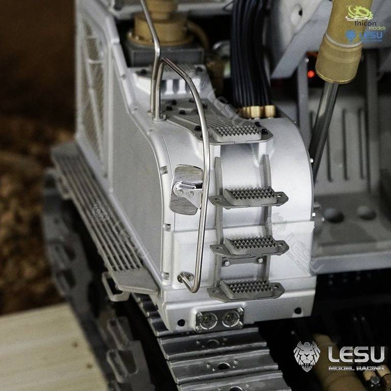 Zbliżenie modelu pojazdu ukazujące gąsienicowy układ jezdny. Szczegółowe przedstawienie mechaniki i struktury, widoczne logo.