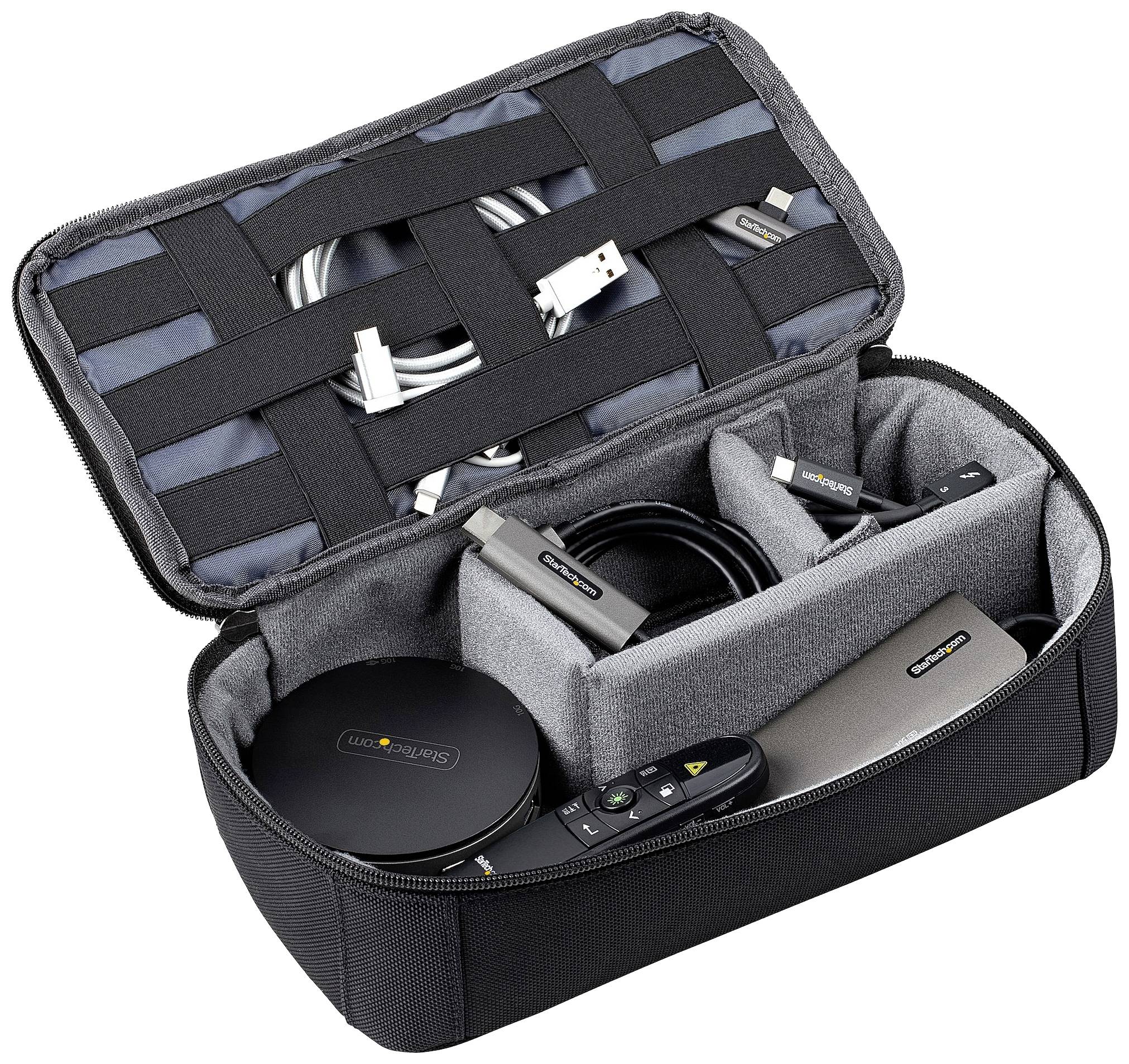 Otwarta torba na ramię z oddzielnymi przegrodami, zawierająca różne urządzenia elektroniczne i kable.