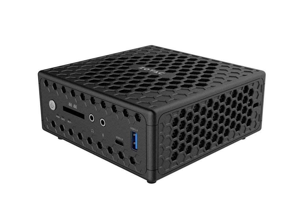 Czarny mini-komputer z wentylacją w kształcie plastra miodu i kilkoma portami z przodu, w tym USB i audio.
