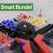 Szczypce do zaciskania leżą na stole przed otwartym pudełkiem z kolorowymi końcówkami kablowymi. W lewym górnym rogu, w zielonym polu, widnieje napis 'Smart Bundel'.