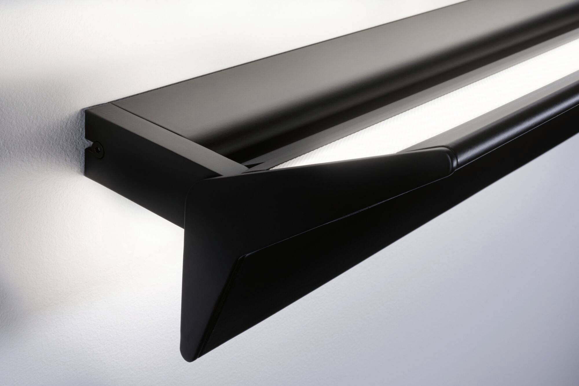 Nowoczesna, czarna kinkiet LED o smukłej sylwetce, zamontowany na białej ścianie. Emituje jasne światło skierowane w dół.