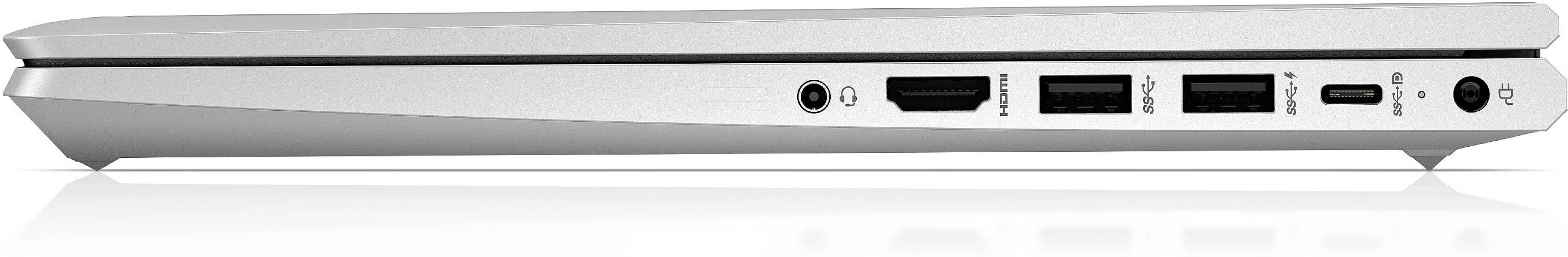Zamknięty laptop widziany z boku, widoczne złącza: HDMI, USB, gniazdo słuchawkowe. Srebrny design, smukła sylwetka.