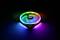 Wentylator obudowy komputera z podświetleniem RGB LED w różnych kolorach, tworzący efekt wizualny w ciemności.