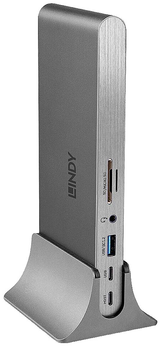 Srebrna stacja dokująca z wieloma portami, w tym USB i slotem na karty pamięci, stoi pionowo na podstawce.