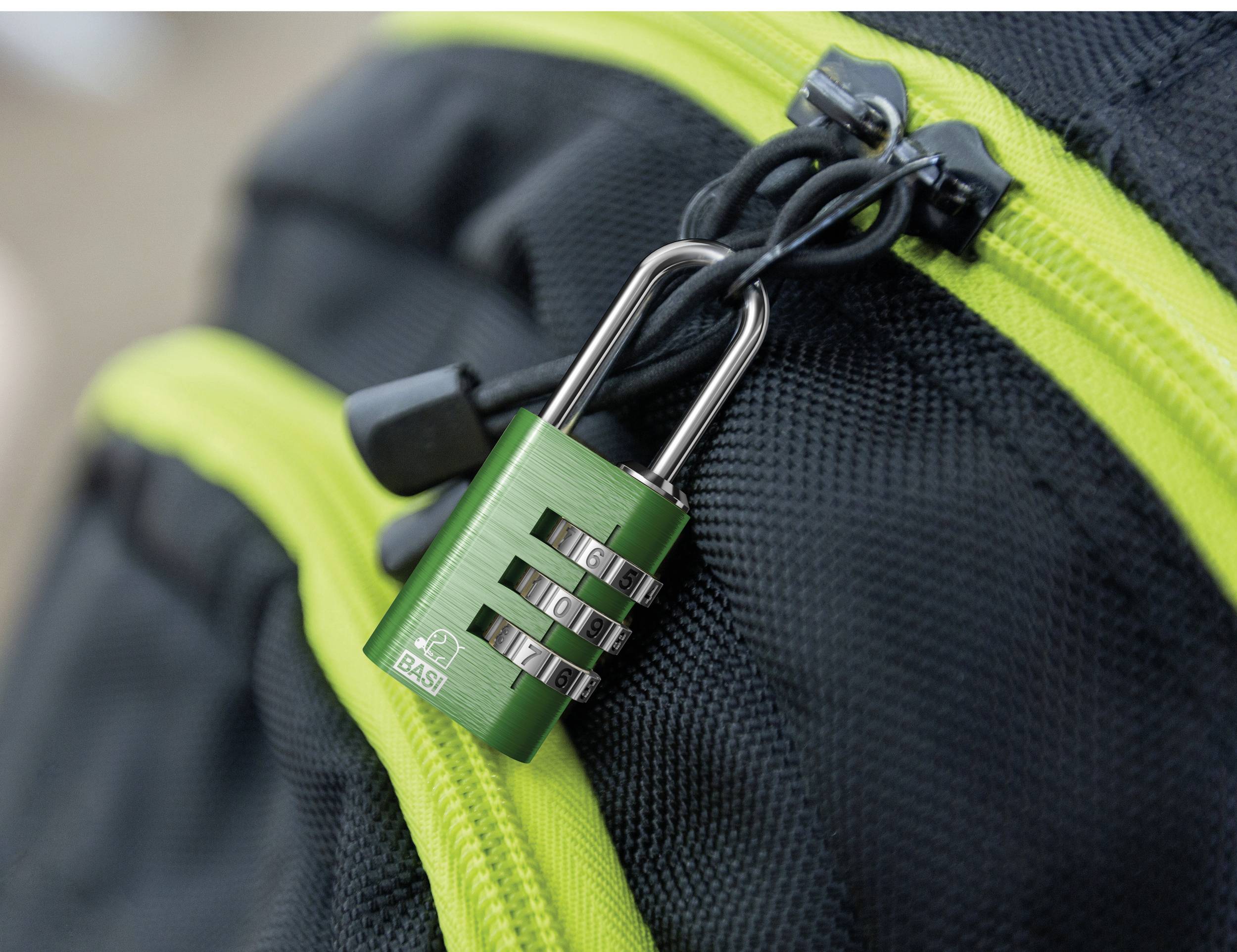 Zielona kłódka na cyfry zabezpiecza zamek błyskawiczny w czarnej torbie z żółtym paskiem.